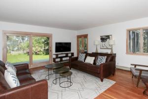 a living room with a couch and a tv at Blackfish Bungalow in Wellfleet