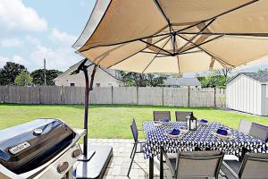 a patio with a table and an umbrella at Harbortown Hideaway in Falmouth
