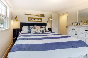 a bedroom with a large blue and white bed at Harbortown Hideaway in Falmouth +20 photos