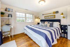 a bedroom with a blue and white bed and a window at Harbortown Hideaway in Falmouth