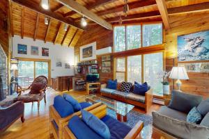 a living room with blue furniture in a log cabin at Old Kings Hideout in Wellfleet