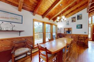 a dining room with a wooden table and chairs at Old Kings Hideout in Wellfleet