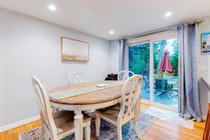 a dining room with a table and chairs at Collingwood Cottage in Yarmouth Port