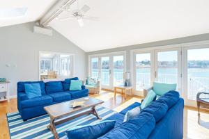 a living room with a blue couch and a table at Island Bay Bungalow in Eastham