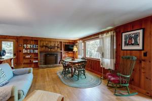 a living room with a couch and a table and chairs at Pickerel Cove Cottage in Mashpee
