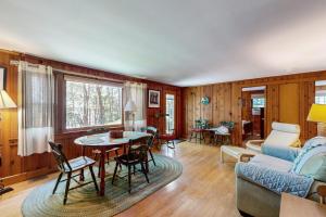 a living room with a couch and a table at Pickerel Cove Cottage in Mashpee