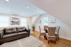a living room with a couch and a table at Oyster Beach Bungalow in Chatham