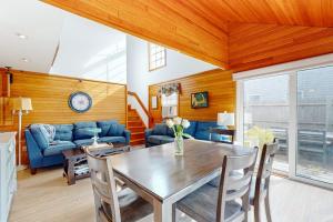 a living room with a table and a blue couch at Trotting Park Paradise in West Dennis
