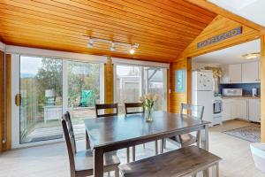 a kitchen and dining room with a table and chairs at Trotting Park Paradise in West Dennis