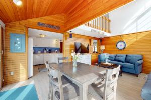 a living room with a table and a blue couch at Trotting Park Paradise in West Dennis +16 photos