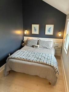a bedroom with a bed with two pictures on the wall at Long Pier Lodge in Provincetown