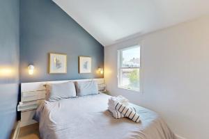 a bedroom with a large bed with a window at Long Pier Lodge in Provincetown