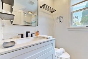 a bathroom with a sink and a mirror and a toilet at Long Pier Lodge in Provincetown +19 photos