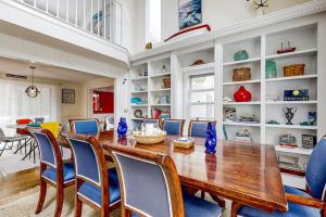 a dining room with a wooden table and blue chairs at Moon Compass Manor in Sandwich