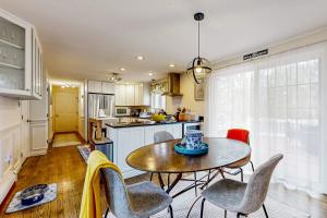 a kitchen with a table and chairs in a room at Moon Compass Manor in Sandwich
