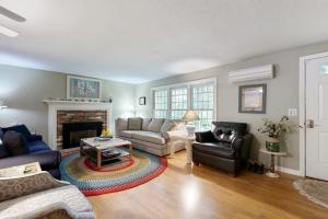 a living room with a couch and a fireplace at Lobster Rock Retreat in Barnstable