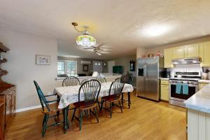 a kitchen and dining room with a table and chairs at Lobster Rock Retreat in Barnstable