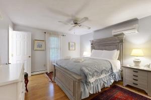 a bedroom with a large bed with a ceiling fan at Lobster Rock Retreat in Barnstable +17 photos
