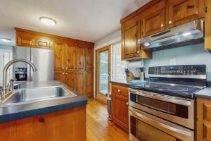 a kitchen with a sink and a stove top oven at Cozy Charming Cottage in Brewster +15 photos