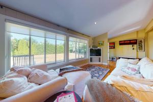a living room with two couches and a large window at Yellow Brick Road House in Oak Bluffs