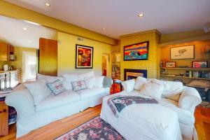 a living room with two white couches and a fireplace at Yellow Brick Road House in Oak Bluffs