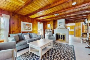 a living room with a couch and a fireplace at Cape Beach Bungalow in Dennis Port