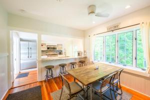 a kitchen and dining room with a wooden table and chairs at East Chop 90 in Oak Bluffs