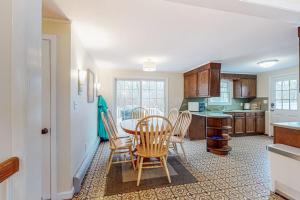 a kitchen with a table and chairs in a room at Jesmond Cottage in Harwich