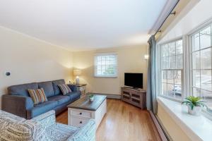 a living room with a couch and a tv at Jesmond Cottage in Harwich