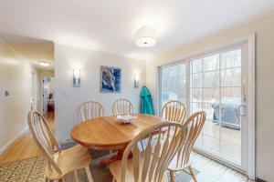 a dining room with a wooden table and chairs at Jesmond Cottage in Harwich +19 photos