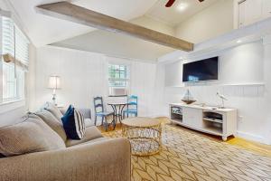 a living room with a couch and a table at Salty Kisses Unit 20 in Yarmouth