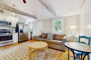 a living room with a couch and a table at Salty Kisses Unit 20 in Yarmouth