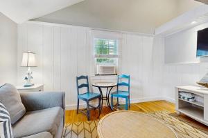 a living room with a couch and two blue chairs at Salty Kisses Unit 20 in Yarmouth