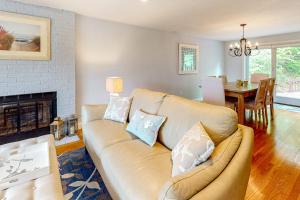 a living room with a couch and a fireplace at Birch Grove in Mashpee