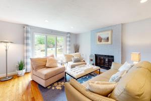 a living room with a couch and a fireplace at Birch Grove in Mashpee