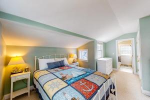 a bedroom with a bed and a table with a night stand at Onset Grove in Onset