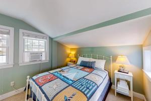 a bedroom with a bed and two windows at Onset Grove in Onset +13 photos