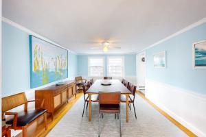a dining room with a table and chairs at Kalmus Park Retreat in Hyannis