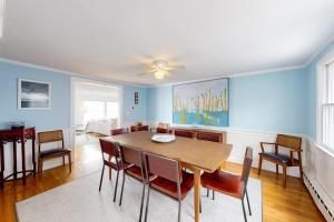 a dining room with a table and chairs at Kalmus Park Retreat in Hyannis