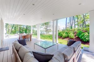 a living room with a couch and a glass table at Follins Estate in Yarmouth Port