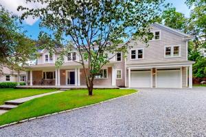 a large white house with a tree in the driveway at Follins Estate in Yarmouth Port