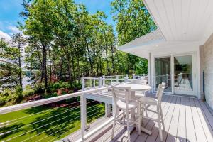 a white deck with a table and chairs on it at Follins Estate in Yarmouth Port