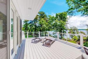 a porch with a table and chairs on a balcony at Follins Estate in Yarmouth Port