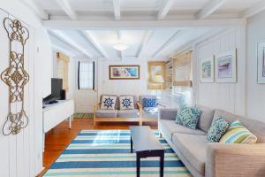 a living room with a couch and a table at Canary Cottage in Oak Bluffs