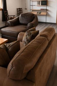 a brown leather couch sitting in a living room at Spahats Creek Resort in Clearwater