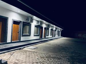 an empty hallway of a building at night at The Mukhiya Palace in Govardhan