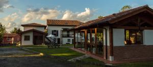 a house with a pavilion in front of it at Apartamentos Rurales Playa del Canal in Villanueva de Pría