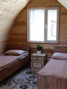 a bedroom with two beds and a window at Arzu Guesthouse in Ak-Say