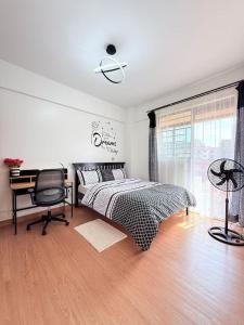 a bedroom with a bed and a desk and a chair at West residence in Ruaka