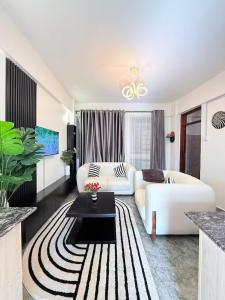 a living room with a white couch and a table at West residence in Ruaka